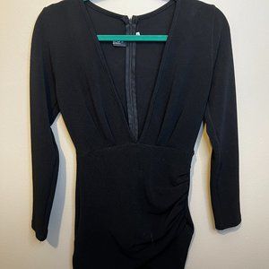 Tight black mini dress with deep vneck